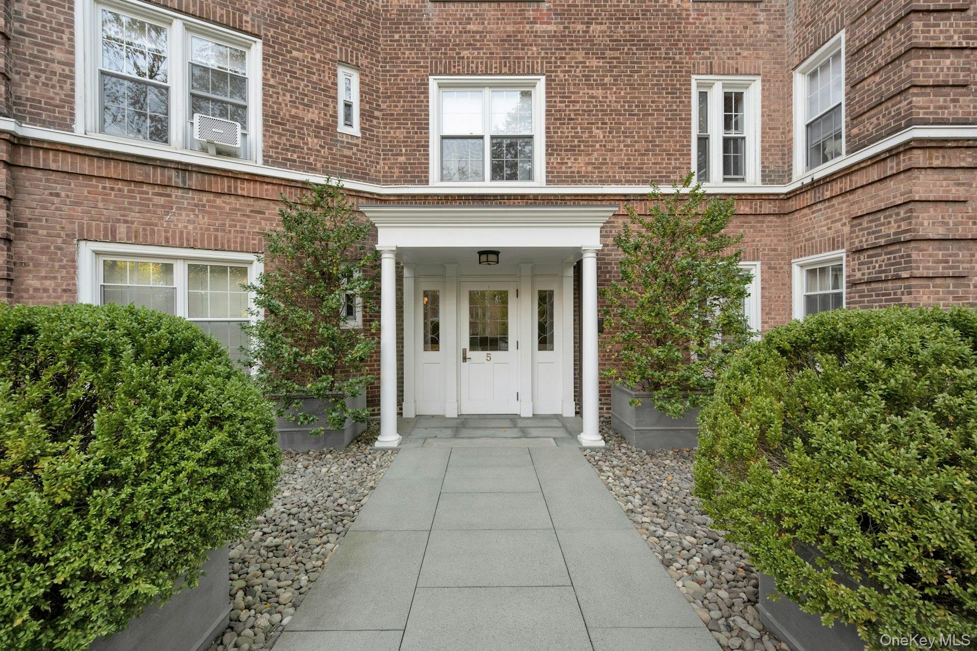 5 Midland Gardens, Unit 3M Bronxville, NY 10708 - Photo 4 of 19 Entrance to property featuring brick siding and covered porch