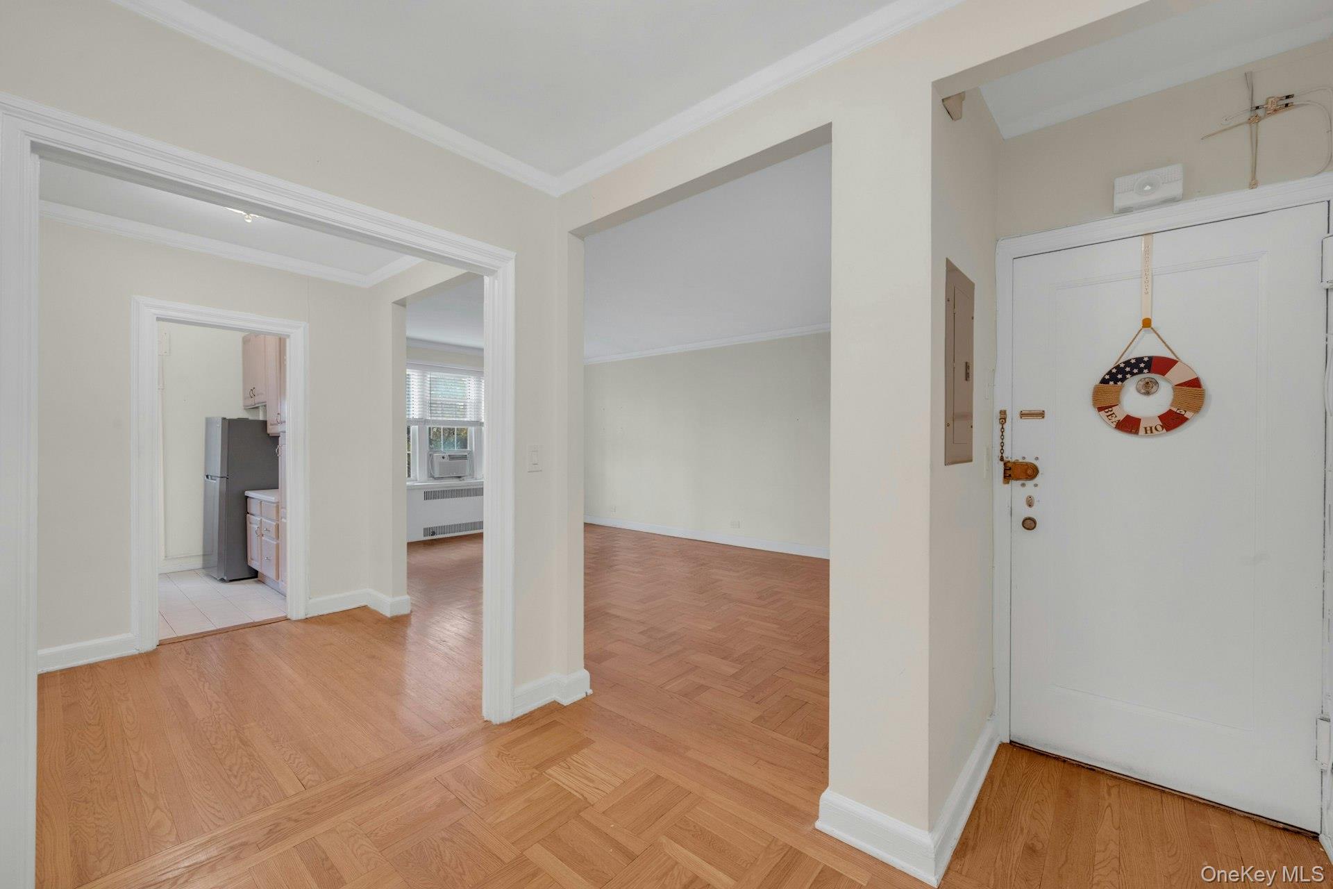 5 Midland Gardens, Unit 3M Bronxville, NY 10708 - Photo 5 of 19 Foyer with ornamental molding and parquet floors