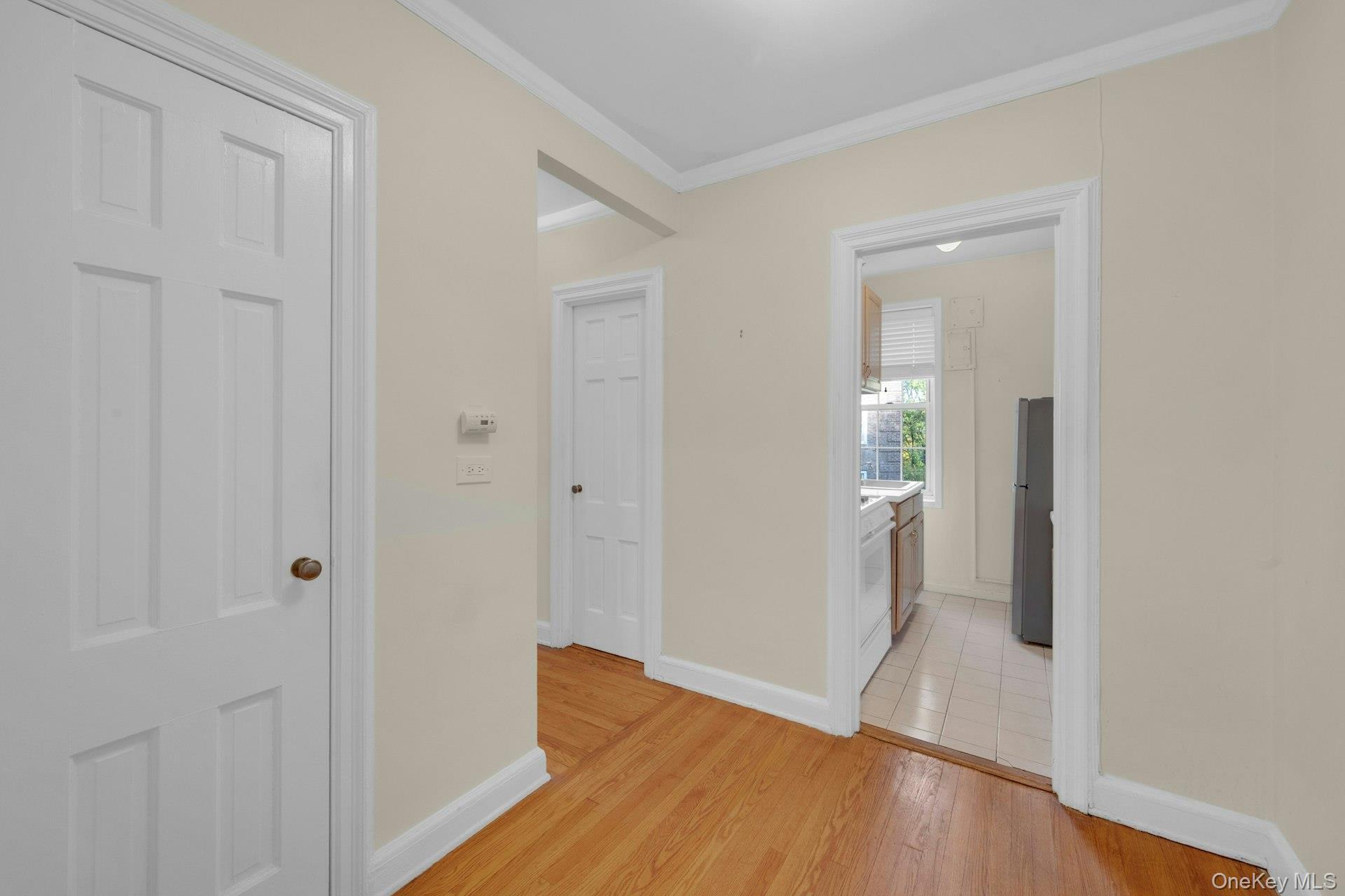 5 Midland Gardens, Unit 3M Bronxville, NY 10708 - Photo 6 of 19 Hallway with light wood-style flooring and crown molding