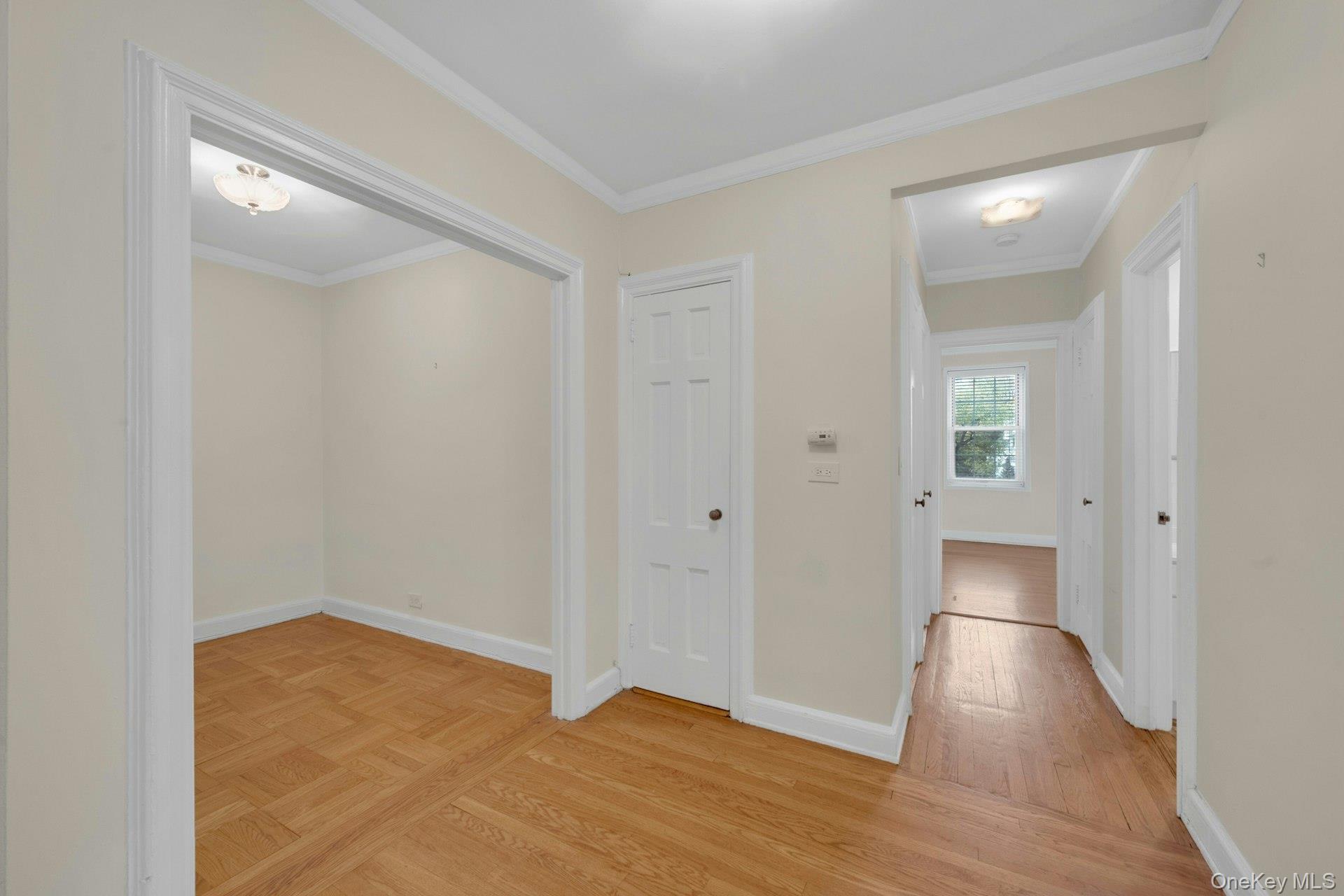 5 Midland Gardens, Unit 3M Bronxville, NY 10708 - Photo 7 of 19 Corridor with ornamental molding and light wood-type flooring
