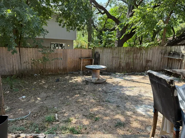 a backyard of a house with table and chairs