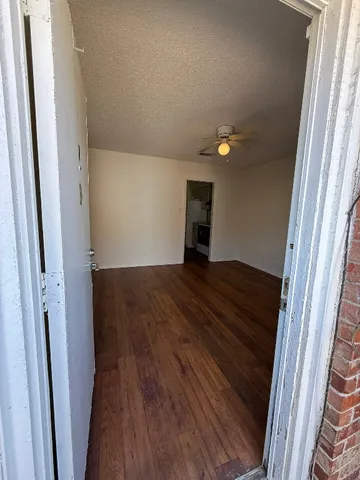 a view of an empty room and wooden floor