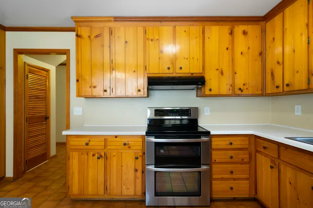 a kitchen with stainless steel appliances granite countertop a stove and a microwave