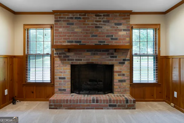 a living room with fireplace furniture and a window