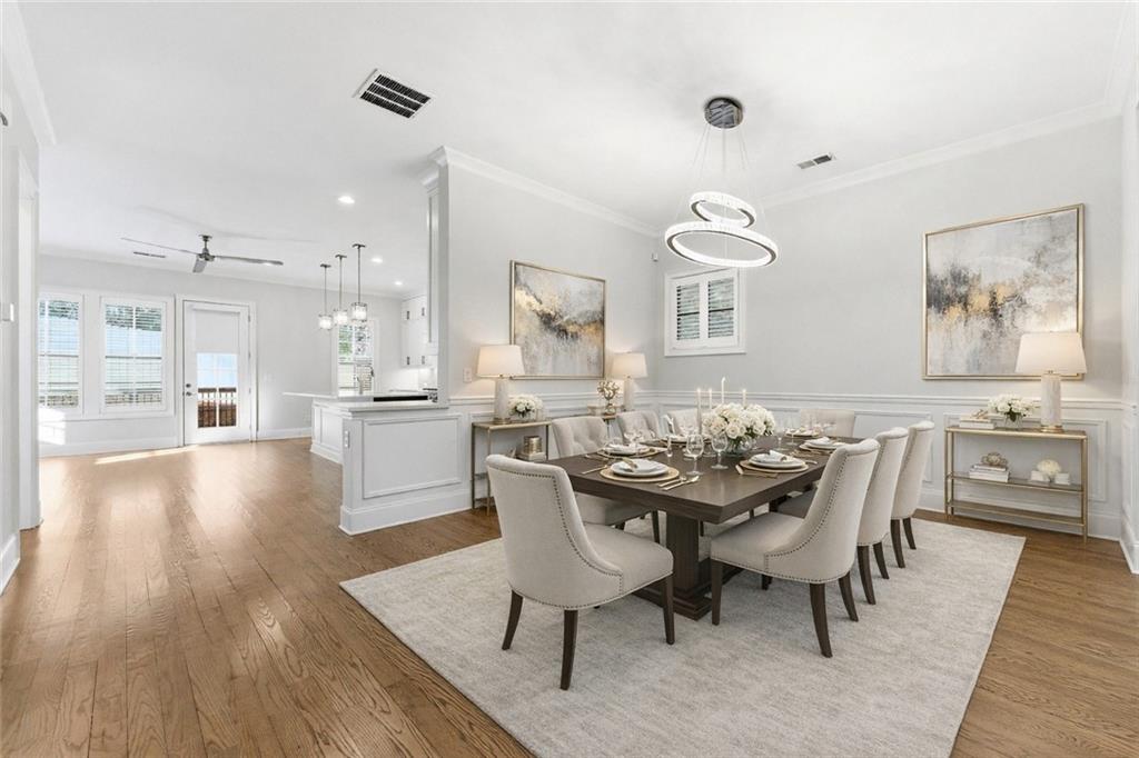 2131 Bellrick Road Northwest Atlanta, GA 30318 - Photo 13 of 57 a view of a dining room with furniture and wooden floor
