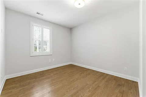 a spacious bedroom with a bed couch and a window