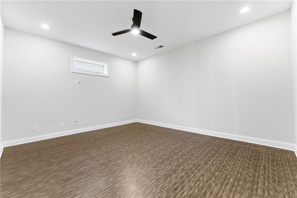 2131 Bellrick Road Northwest Atlanta, GA 30318 - Photo 40 of 57 an empty room with wooden floor and windows