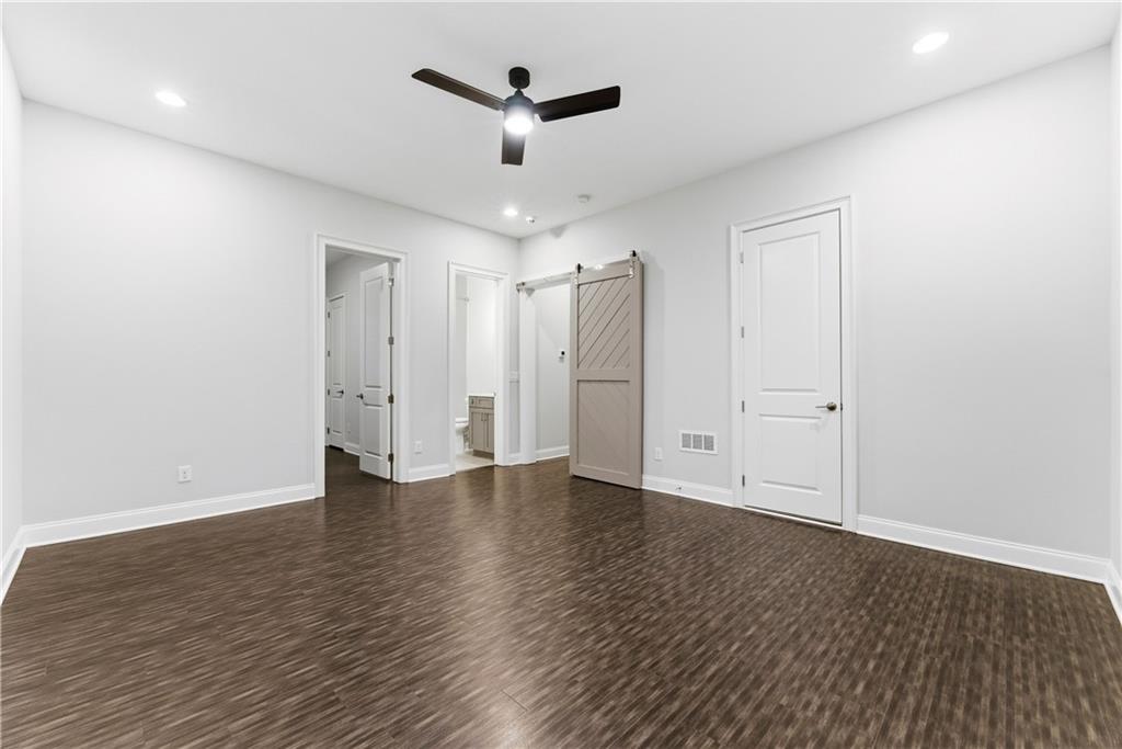 2131 Bellrick Road Northwest Atlanta, GA 30318 - Photo 41 of 57 an empty room with wooden floor and ceiling fan
