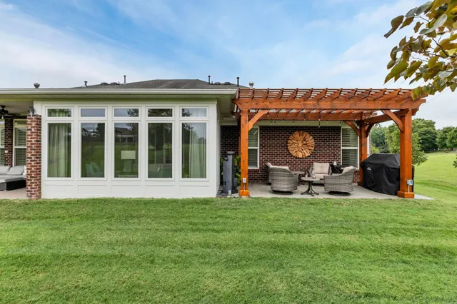 a view of a house with yard and sitting area