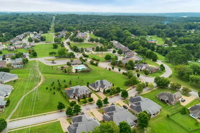 an aerial view of a house with yard swimming pool and outdoor seating