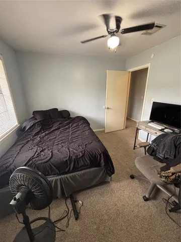 a bedroom with a bed and a chair