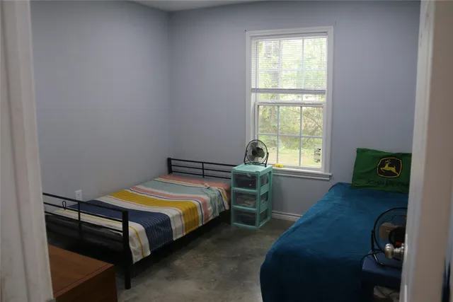 a bedroom with a bed and a window