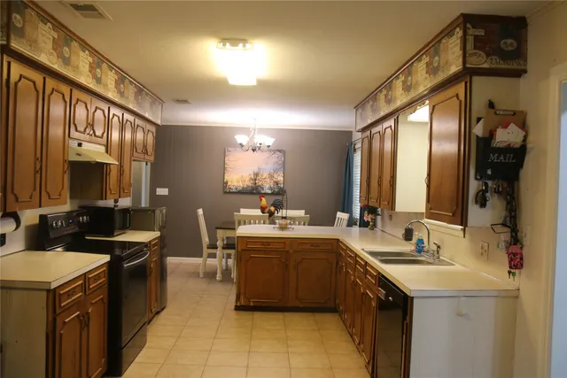 a kitchen with a sink and stove