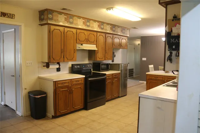 a kitchen with a sink stove and cabinets