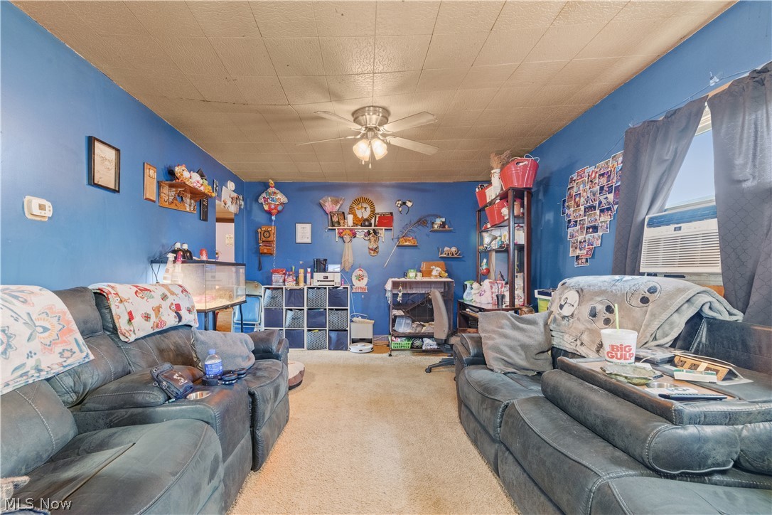 68-70 East Sunset Drive Rittman, OH 44270 - Photo 8 of 49 Spacious room featuring blue-painted walls and light-toned ceiling panels