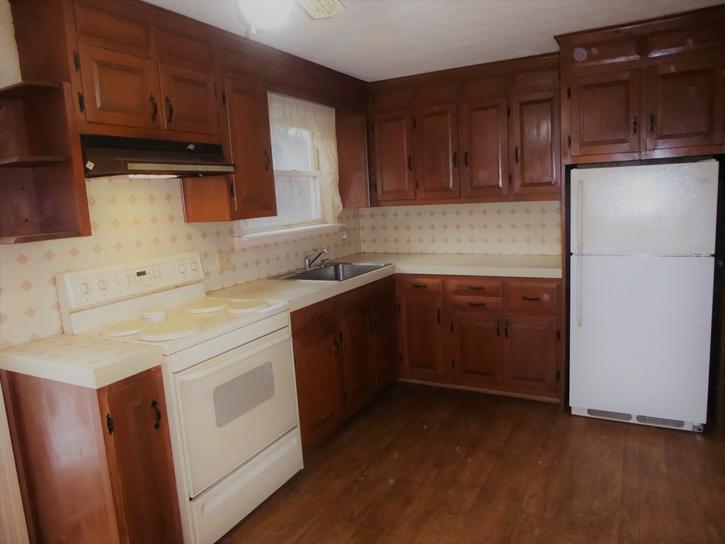 100 Hudson Street Springfield, MA 01118 - Photo 8 of 30 a kitchen with a sink a stove a refrigerator and cabinets