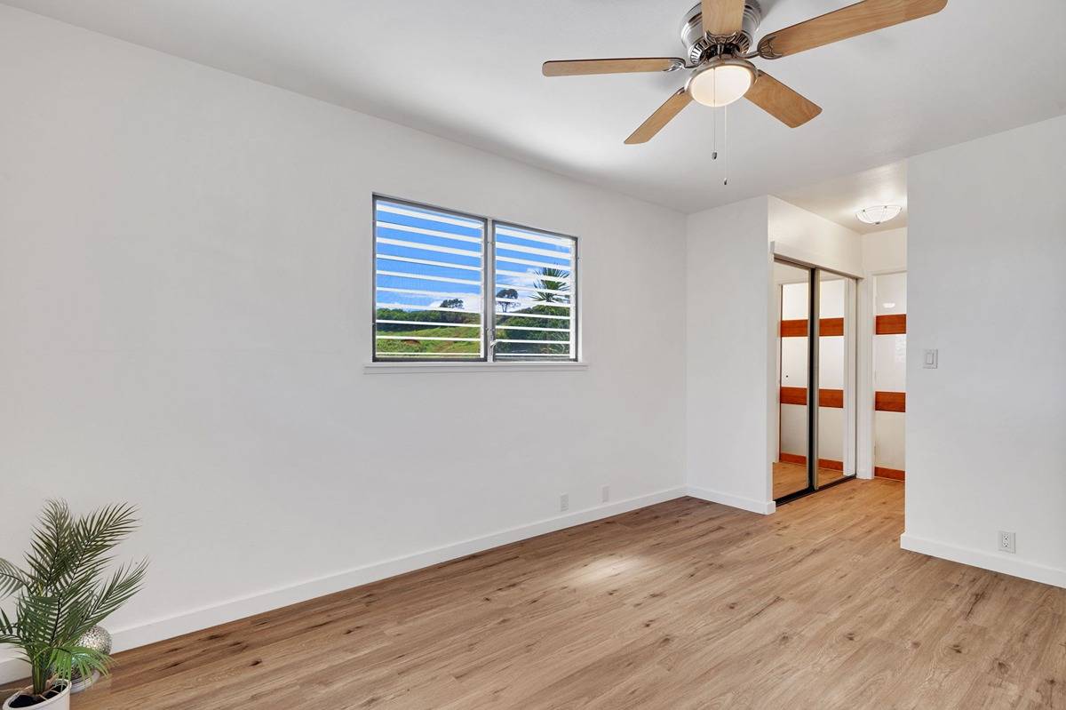 4920 Aliali Road, Unit 11 Kapaa, HI 96746 - Photo 15 of 30 a view of an empty room with wooden floor and a window