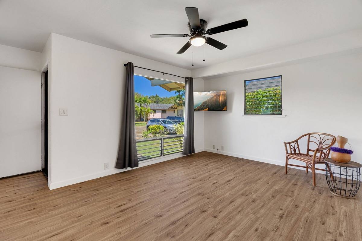 4920 Aliali Road, Unit 11 Kapaa, HI 96746 - Photo 3 of 30 a view of room with wooden floor and ceiling fan