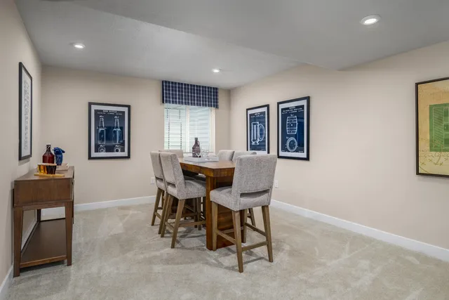 a view of a dining room with furniture and a window