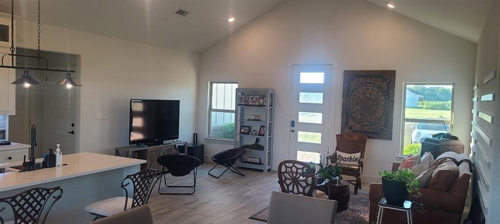 1589 Stiles Road Whitesboro, TX 76273 - Photo 6 of 22 a work room with furniture and wooden floor