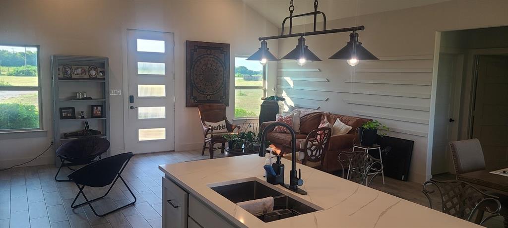 1589 Stiles Road Whitesboro, TX 76273 - Photo 8 of 22 a kitchen with sink cabinets and window