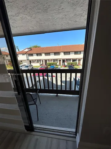 a view of a patio with table and chairs