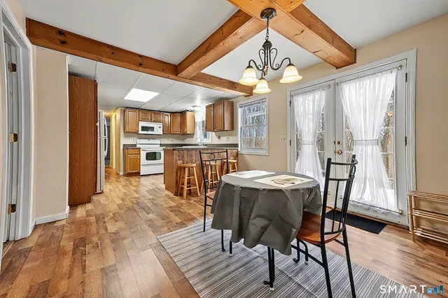 a view of a dining room with furniture window and wooden floor