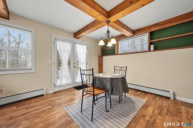 a workspace with wooden floor and windows