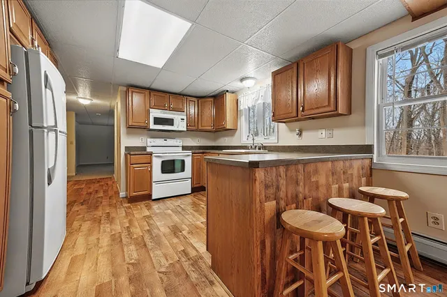 a kitchen with stainless steel appliances granite countertop a sink a stove and a refrigerator
