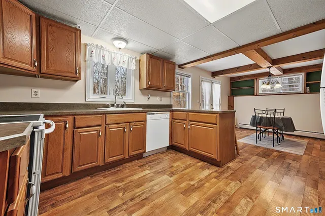a kitchen with stainless steel appliances granite countertop a stove sink and cabinets