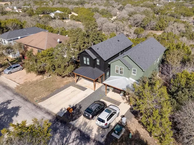 an aerial view of a house with yard and mountain view in back