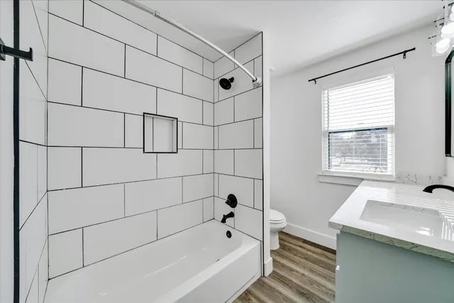 a bathroom with a bathtub and next to a window