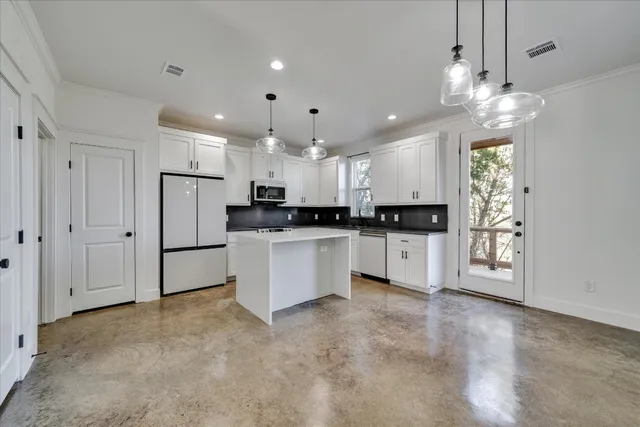 a large kitchen with cabinets and stainless steel appliances