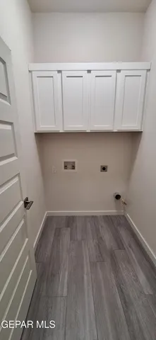 a view of hallway with stairs and wooden floor