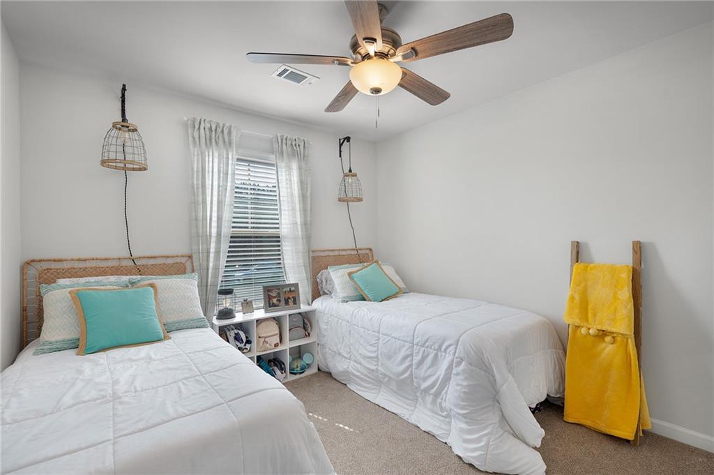 405 Crowley Drive Calhoun, GA 30701 - Photo 18 of 33 a bedroom with a bed and a chandelier
