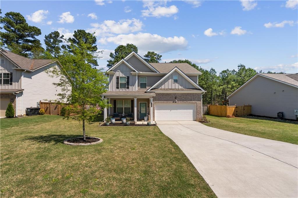 405 Crowley Drive Calhoun, GA 30701 - Photo 2 of 33 a front view of a house with a yard and garage