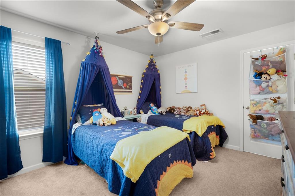 405 Crowley Drive Calhoun, GA 30701 - Photo 25 of 33 a bedroom with 2 bed and a chandelier