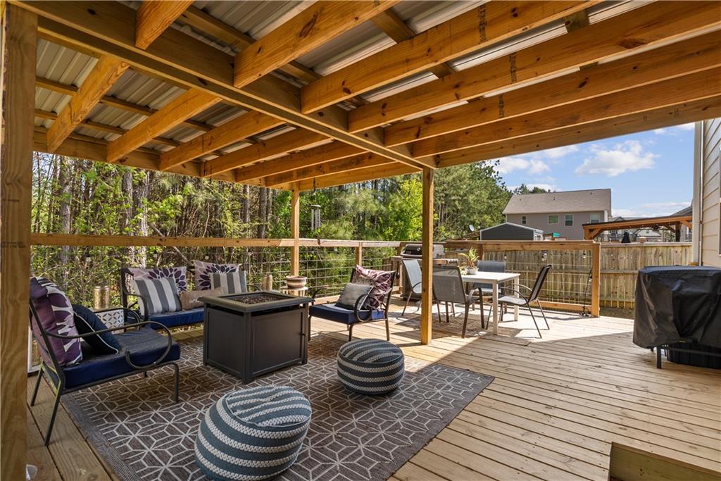 405 Crowley Drive Calhoun, GA 30701 - Photo 28 of 33 a view of a roof deck with table and chairs barbeque with wooden floor