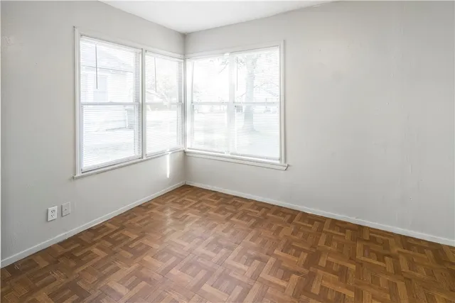 an empty room with wooden floor