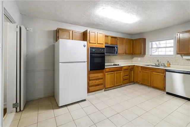a kitchen with cabinets and white stainless steel appliances
