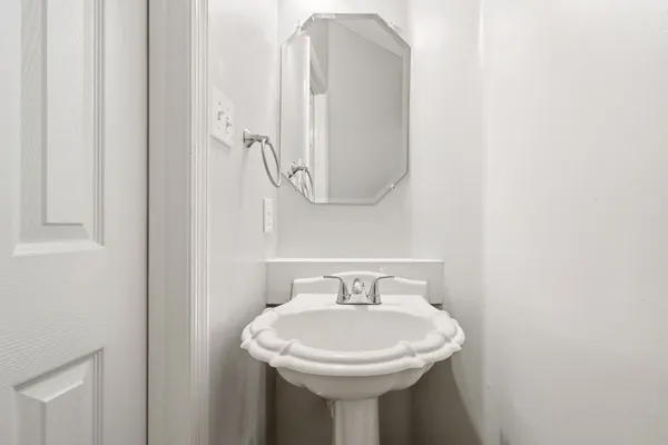 a bathroom with a sink a mirror and bathtub