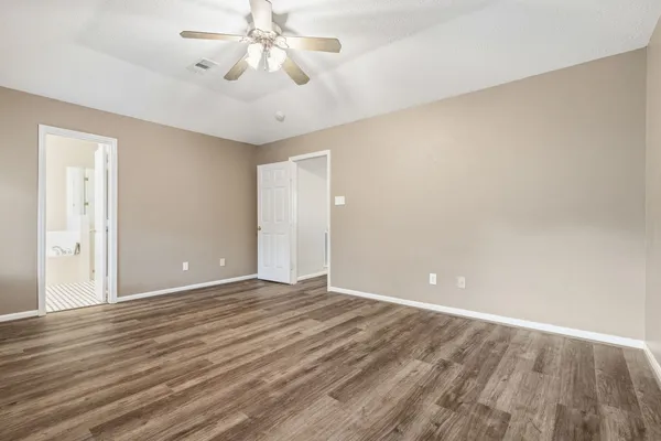 a view of an empty room with wooden floor
