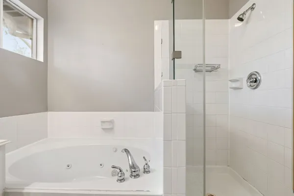 a bathroom with a bathtub and shower