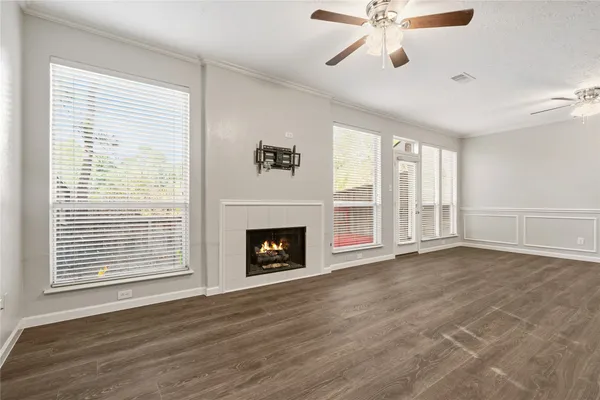 a view of an empty room with a window and fireplace