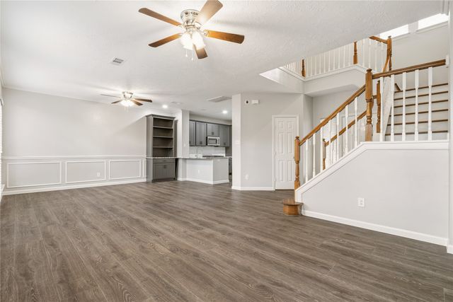 a kitchen with granite countertop a refrigerator and a sink