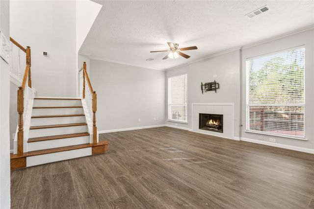 a view of an empty room with wooden floor