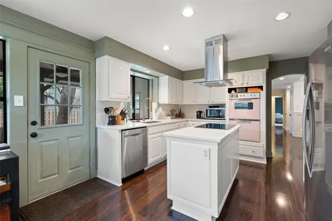 a kitchen with white cabinets and white appliances