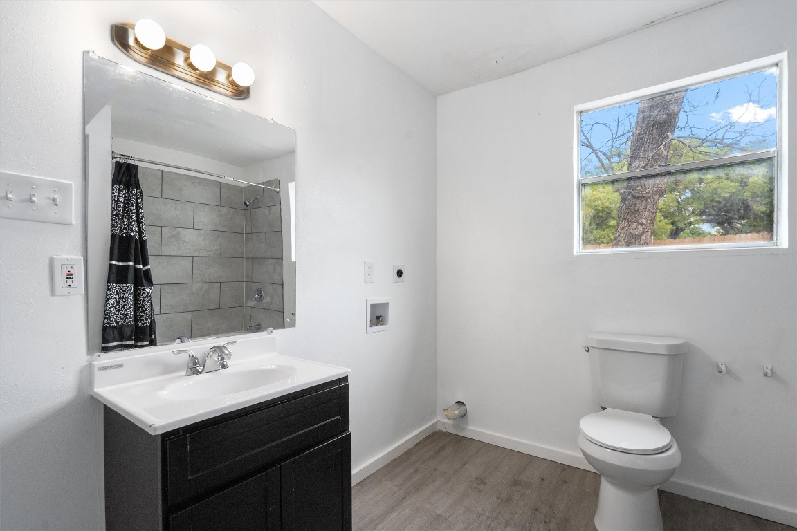 10205 Old Manchaca Road, Unit B Austin, TX 78748 - Photo 14 of 24 a bathroom with a sink toilet and a mirror