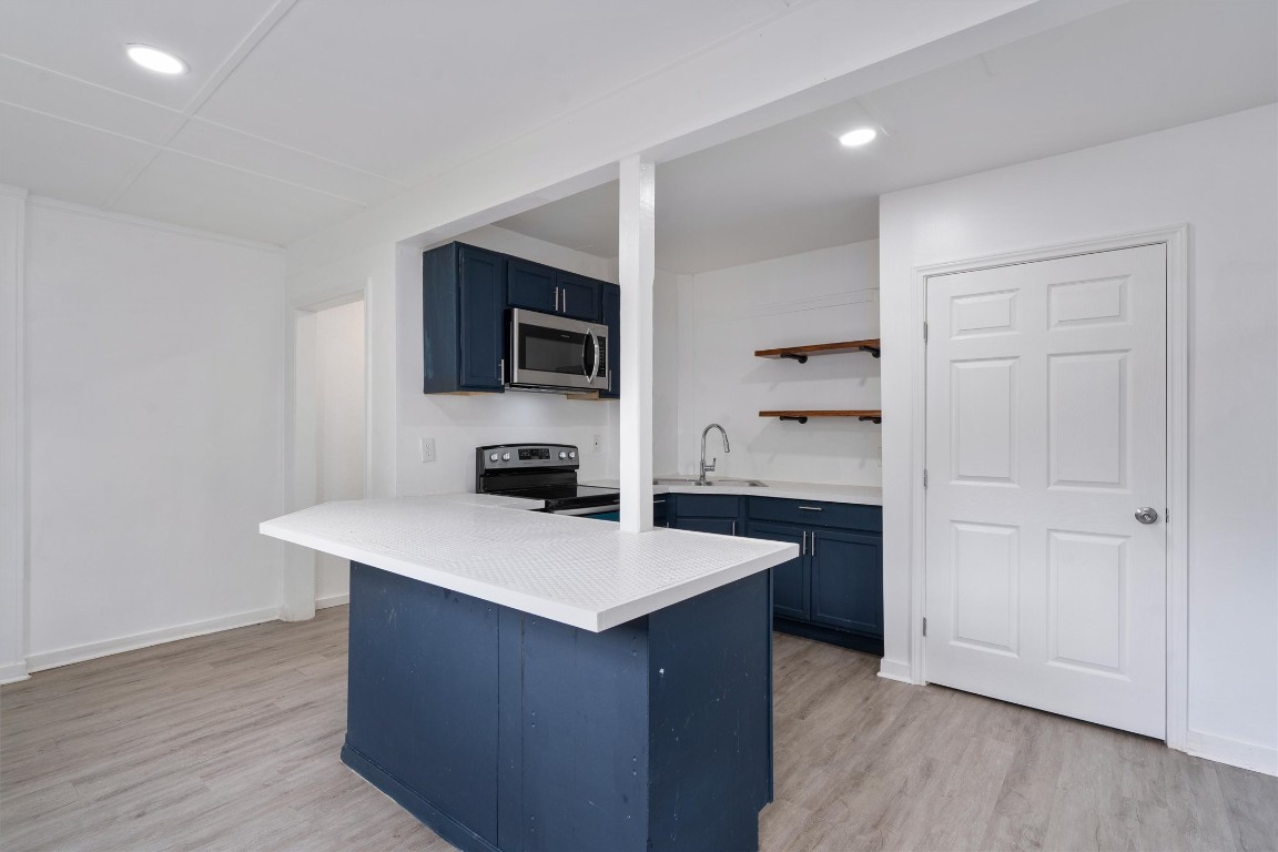 10205 Old Manchaca Road, Unit B Austin, TX 78748 - Photo 18 of 24 a kitchen with a sink cabinets and wooden floor