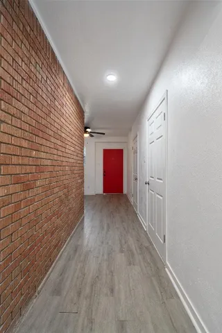 a view of hallway with wooden floor